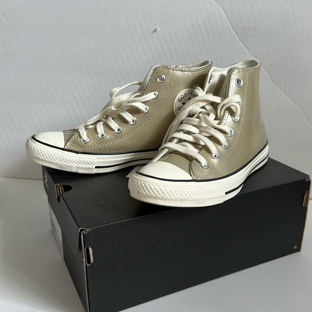 Gold Converse high top shoes